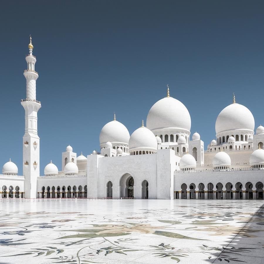 White domes and arches of the Sheikh Zayed Grand Mosque.